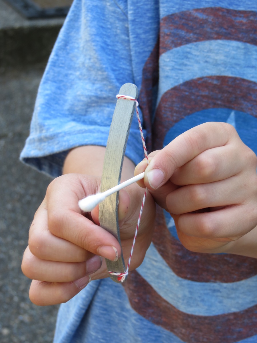 Make a bow and arrow out of a Popsicle stick